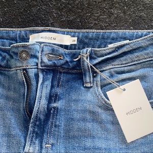 The brand is hidden, they are light blue distressed mom jeans, size is 28!